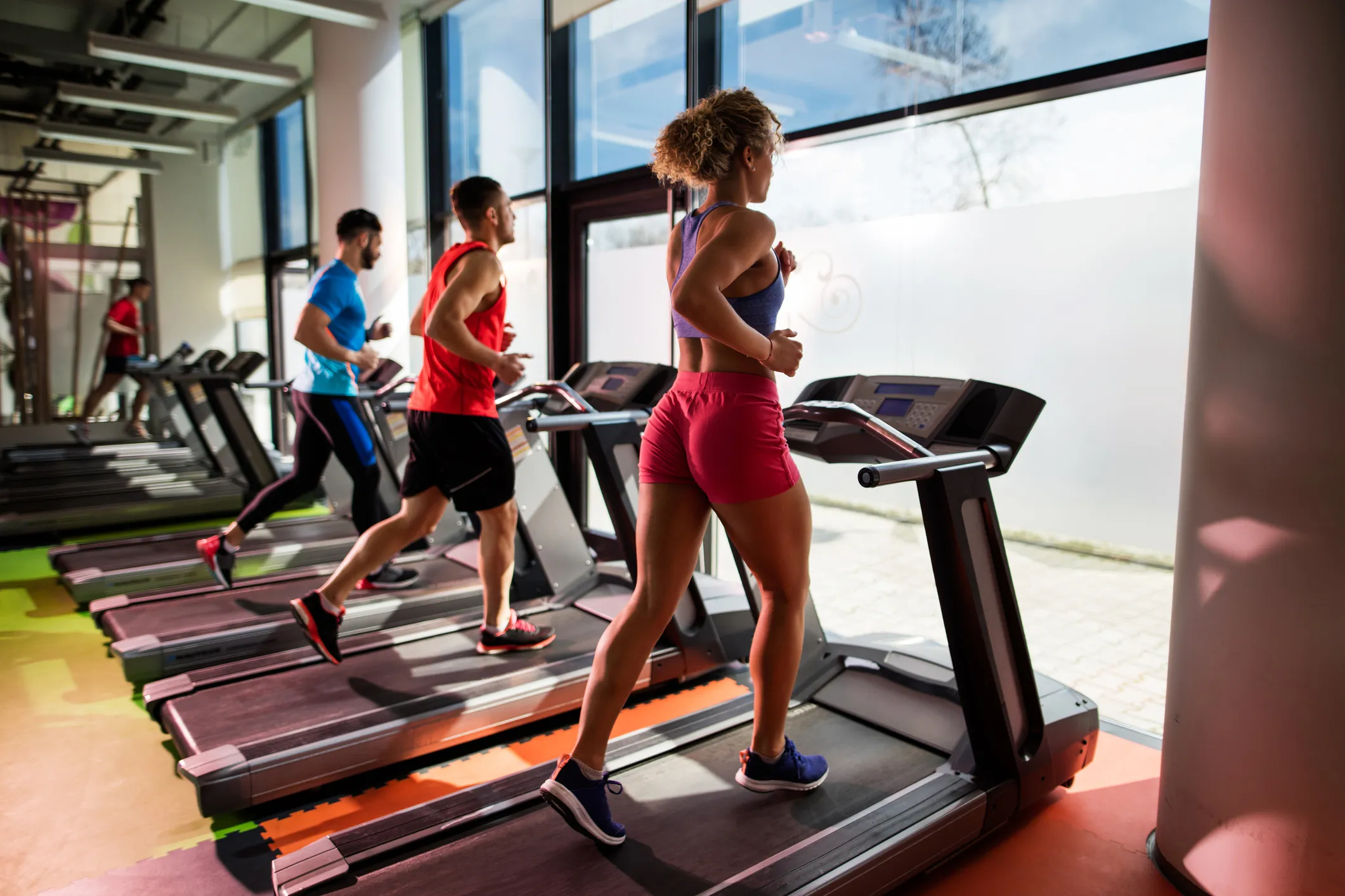 small group of young people running on treadmill in royalty free image 1569853245